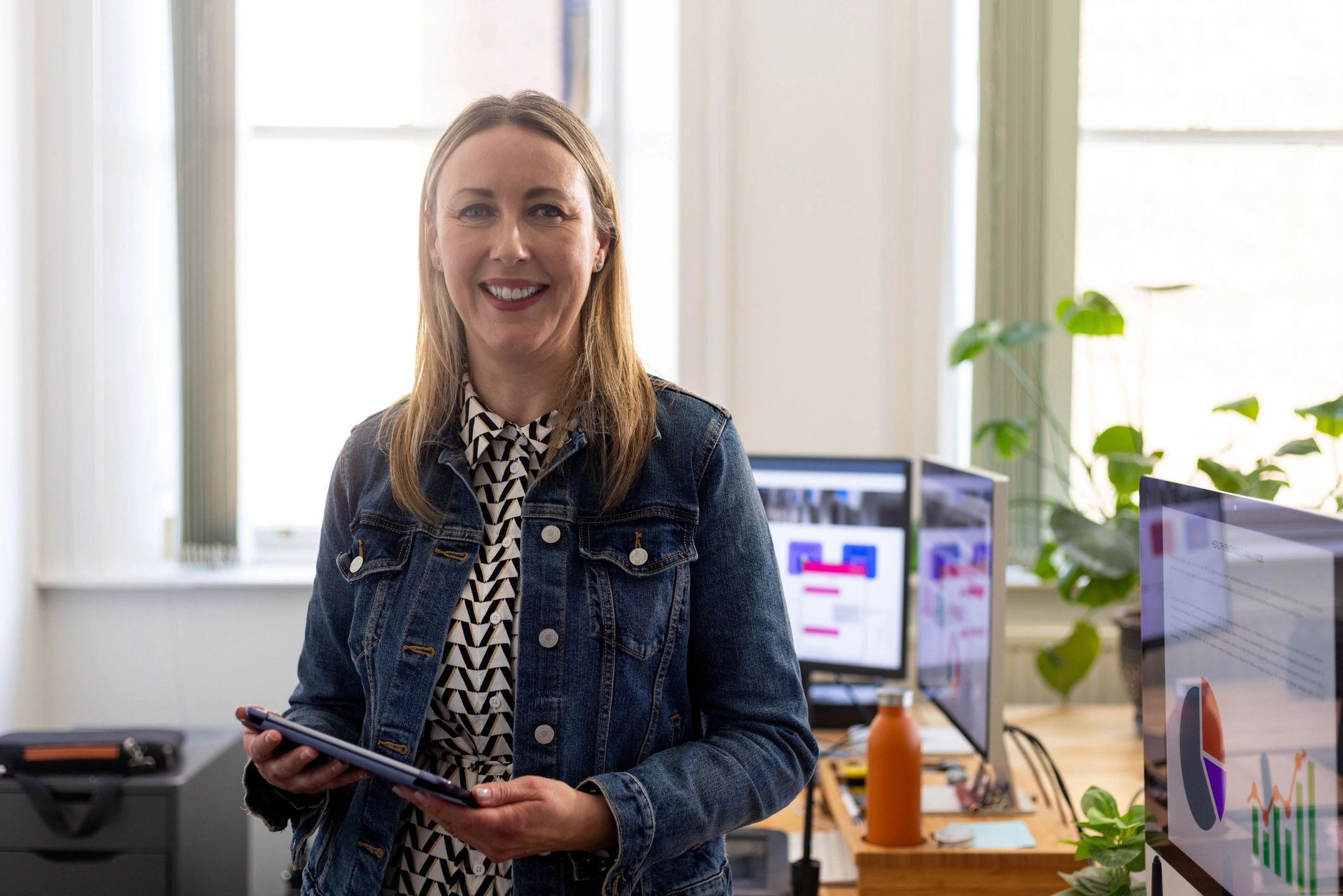 Businesswoman holding tablet in modern office